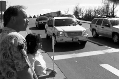 A student with a cane travel instructor working on street crossing at the Colorado Center for the Blind.