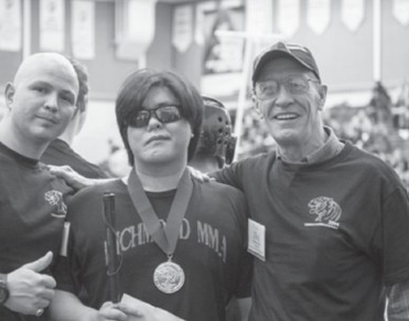 Johnny Tai shows off his medal won at the 2014 Tiger Balm International competition. Photo Courtesy of Richmond News