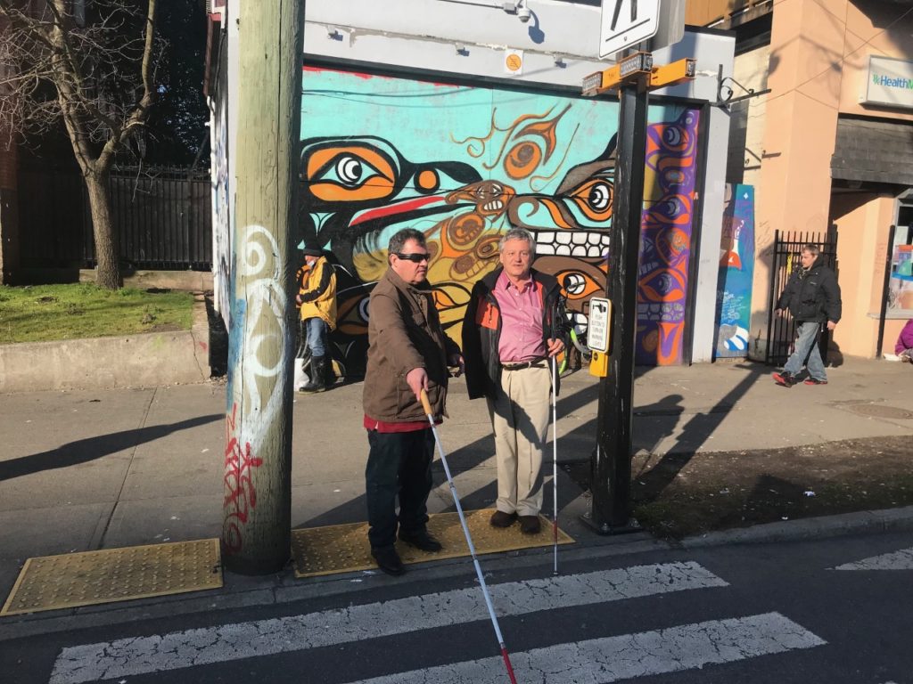 CFB President Doug Lawlor & 1st Vice President Oriano Belusic prepare to cross a Pandora Ave bike lane in Victoria to get to the floating island bus stop.